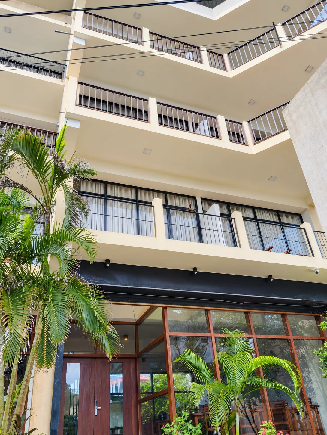 Chaaya Inn facade with balconies and palms