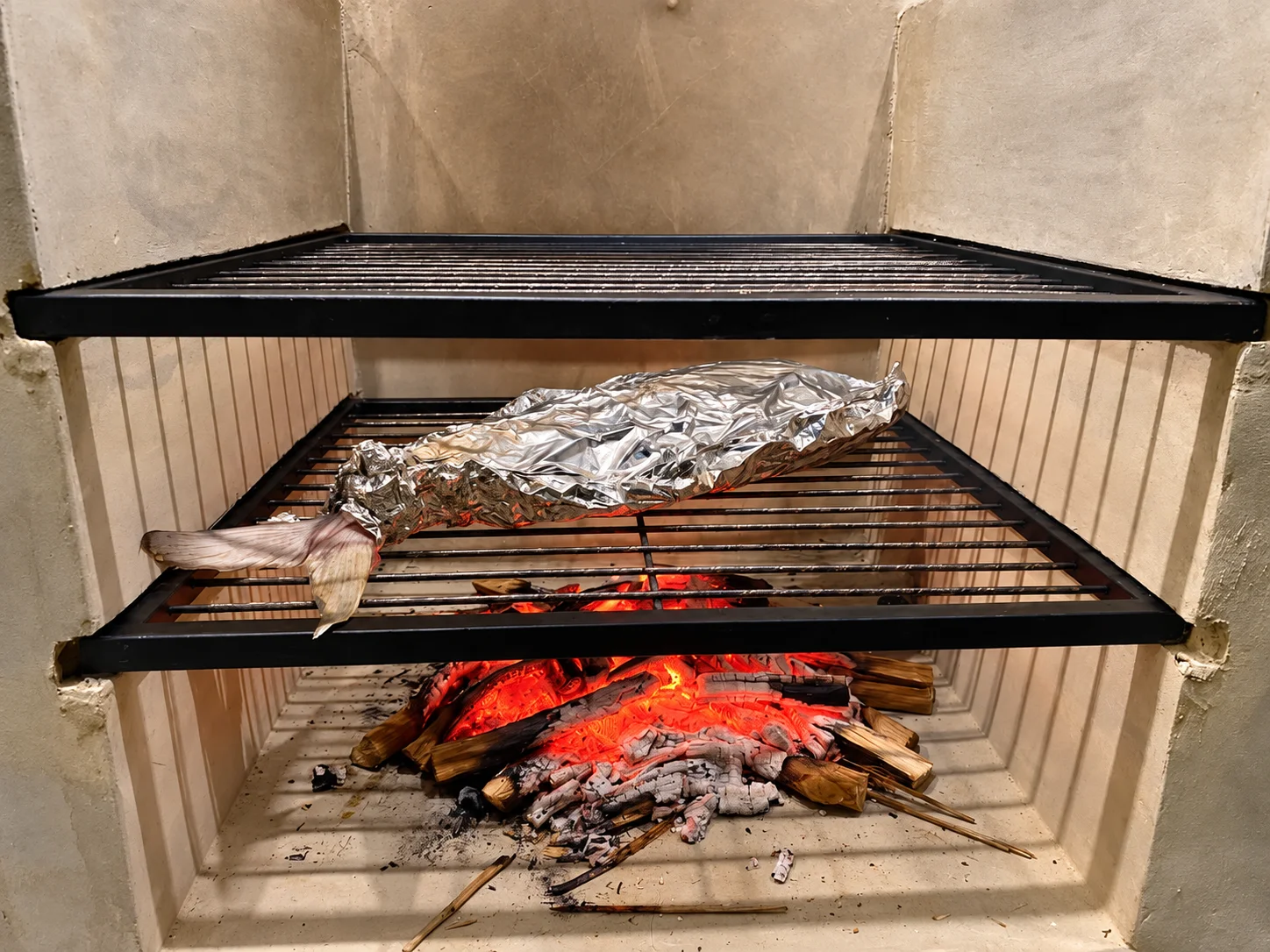Foil-Wrapped Fish Over Glowing Embers
