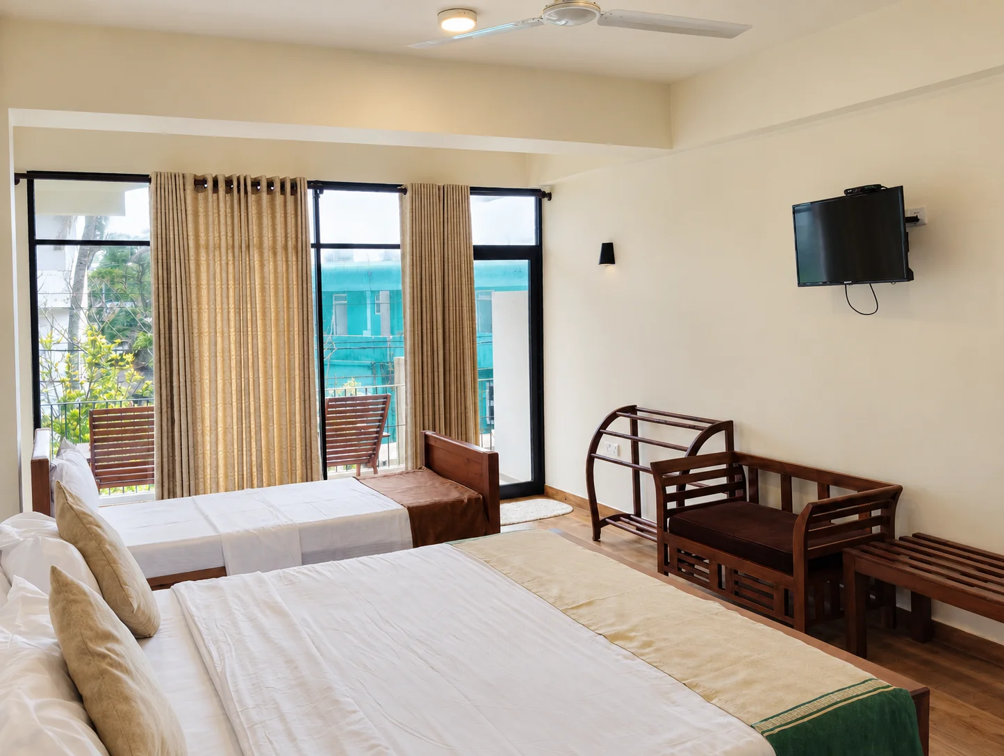 Spacious Family Room with Comfortable Beds and Balcony Access
