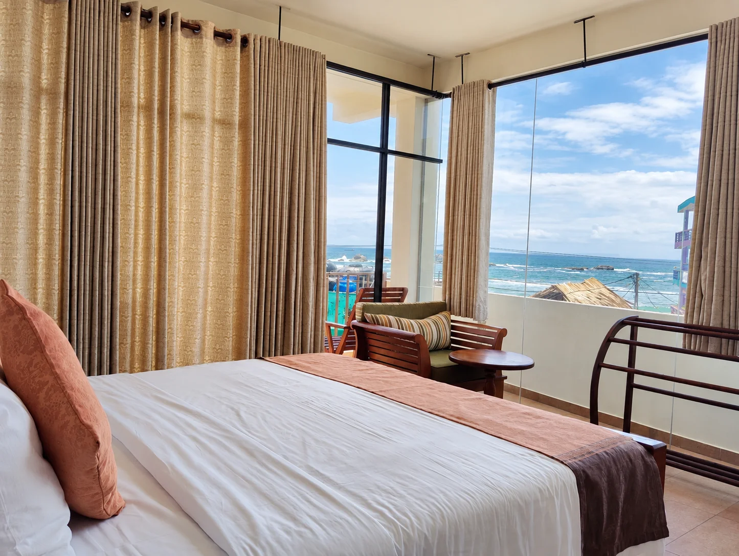 Bright Ocean-View Bedroom with Comfortable Seating