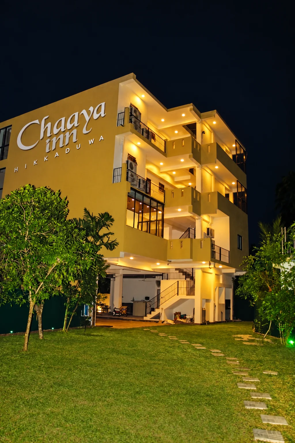 Chaaya Inn at golden hour surrounded by palms